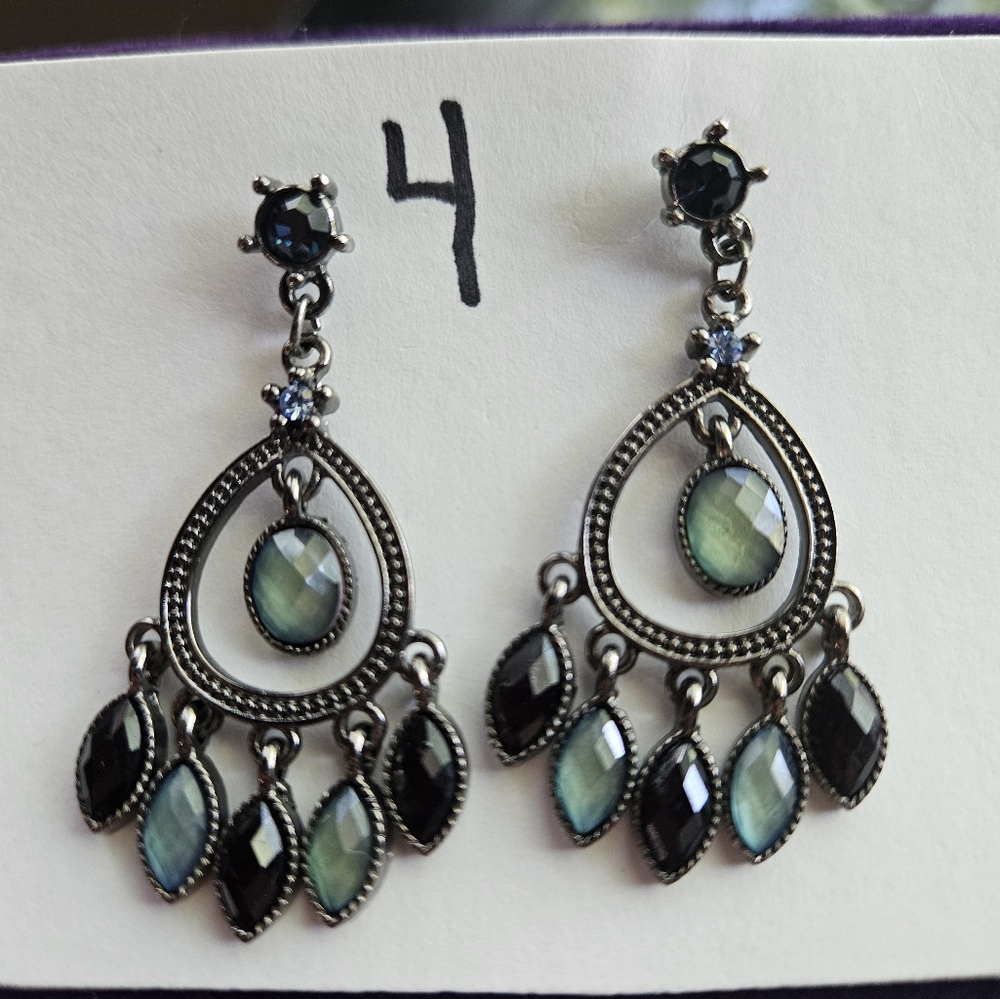 Silver tone chandelier earrings with beautiful green gems.